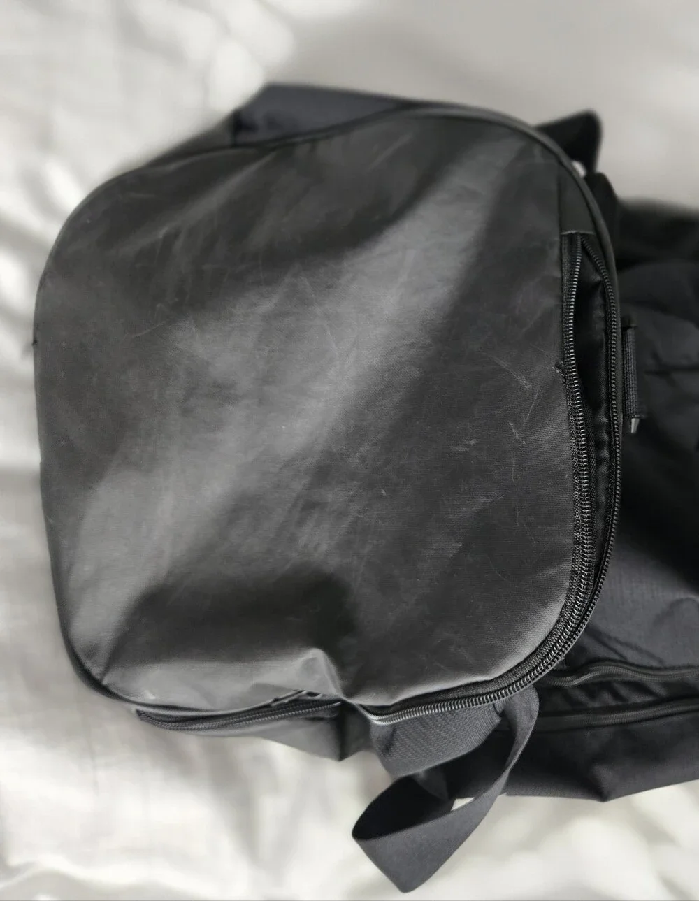 Nike Black Duffel Bag with White Swoosh and Bottom Zipper Pocket.